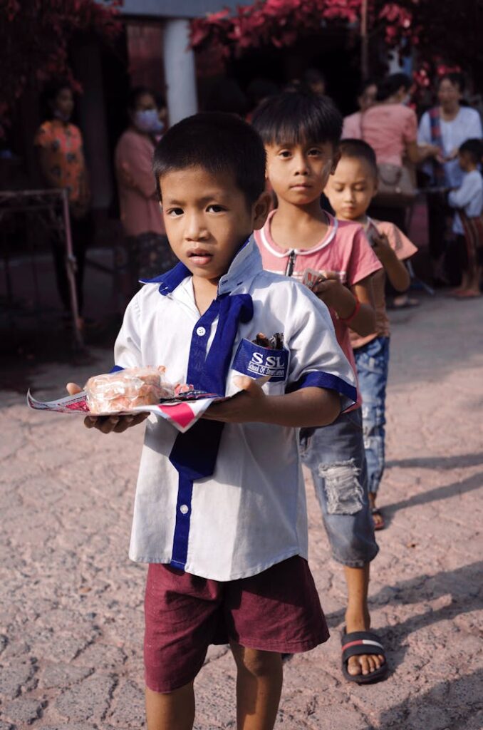 Lined Up Children Carrying Food